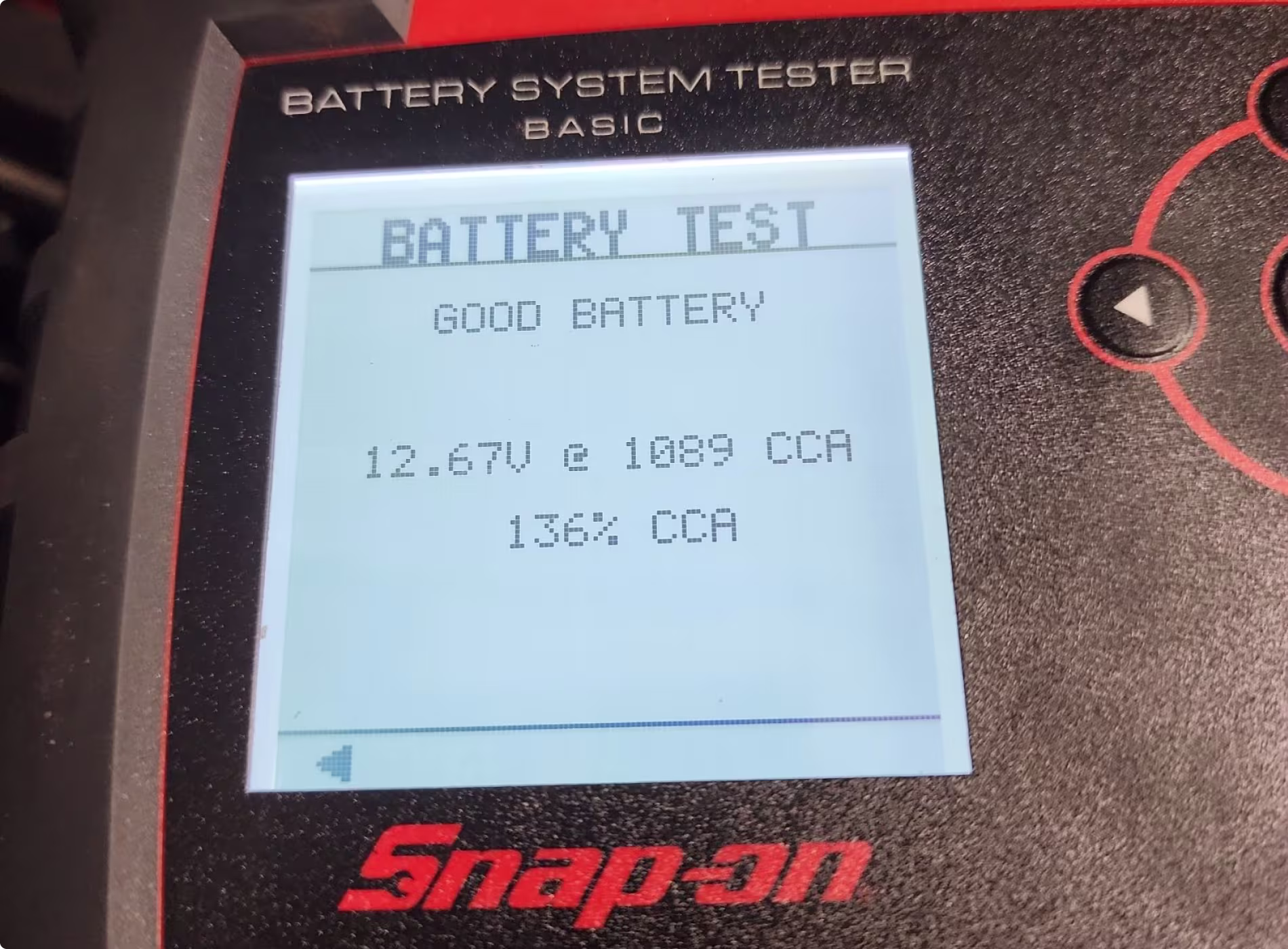 Close-up of a Snap-on battery tester screen displaying Battery Test, Good Battery, 12.67V @ 1089 CCA, and 136% CCA, indicating the battery is in good condition.